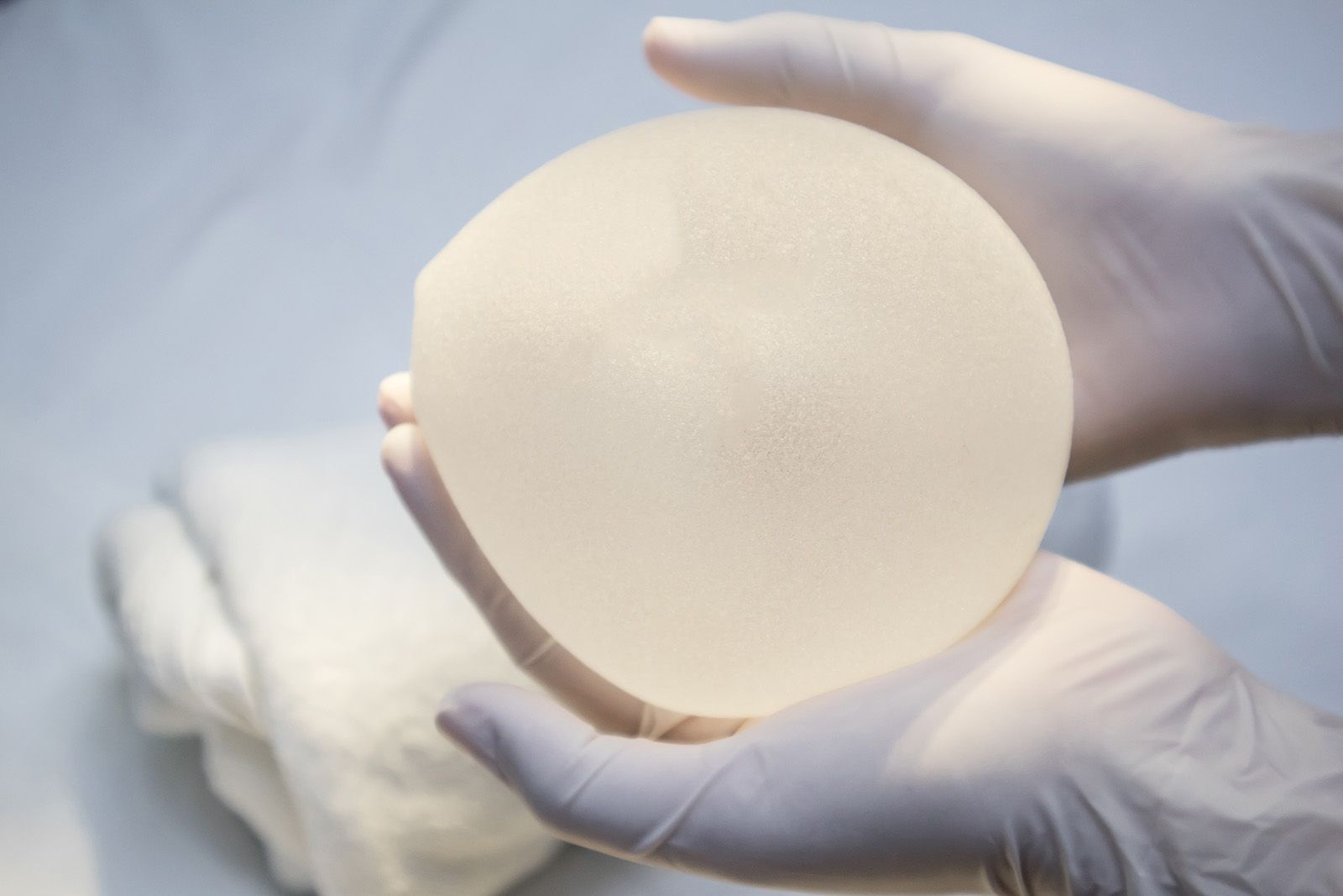 Doctor holding breast implant